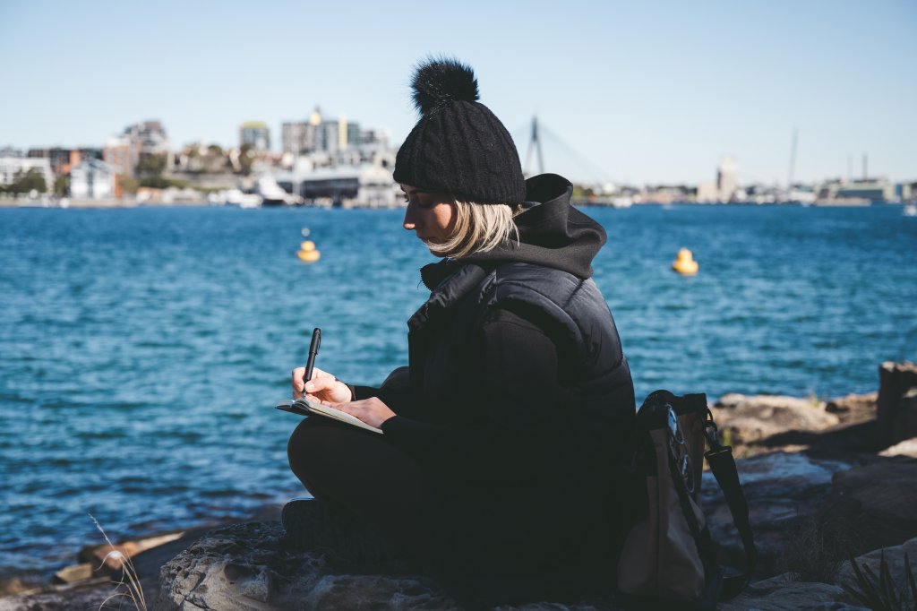 Woman writing down her thoughts and reflecting using Pilot fountain pen and paper.